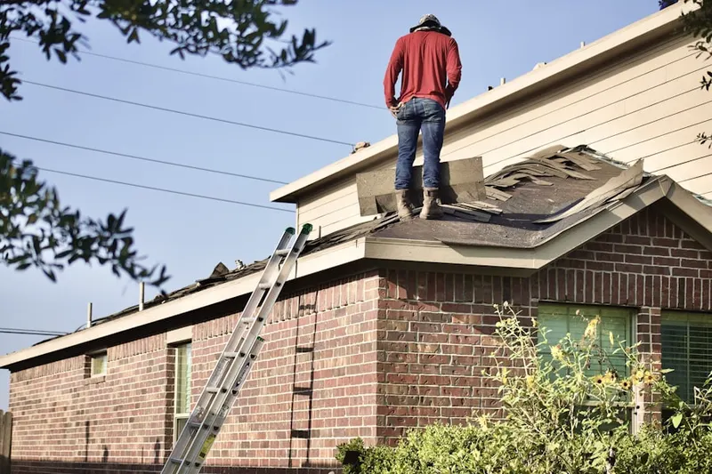 Professional roofer working on a residential roof in High Ridge